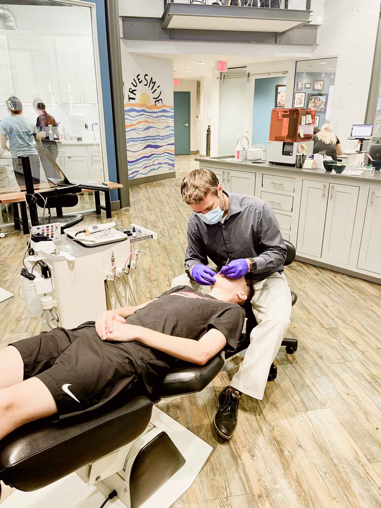 Team member examining patient's teeth